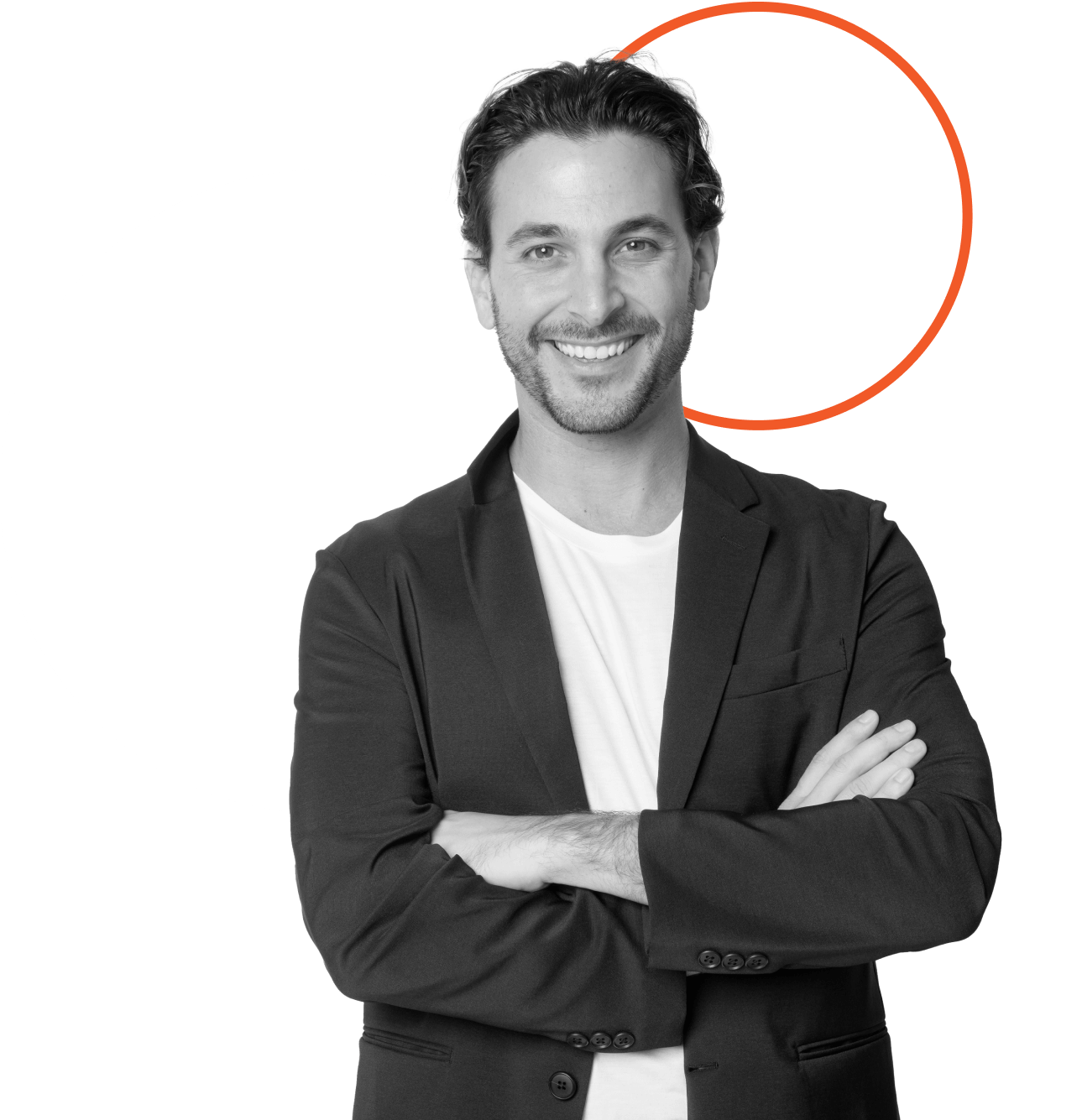 A smiling man with wavy hair, wearing a dark blazer and white shirt, stands with his arms crossed. Behind him are a large white circle and a thin orange circle on a plain background.